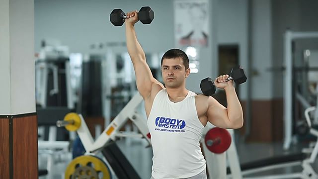 Photo of Standing Alternating Dumbbell Press exercise