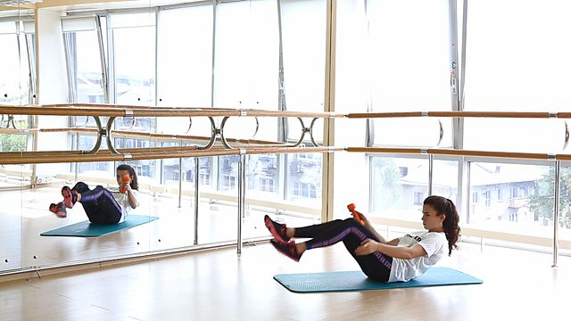 Photo of Passing dumbbell underfoot in folding exercise