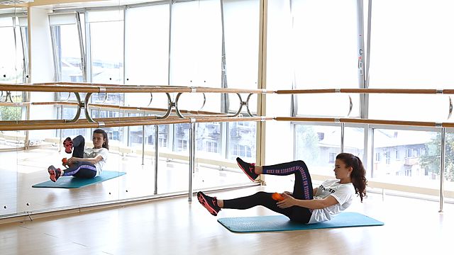 Photo of Passing dumbbell underfoot in folding exercise