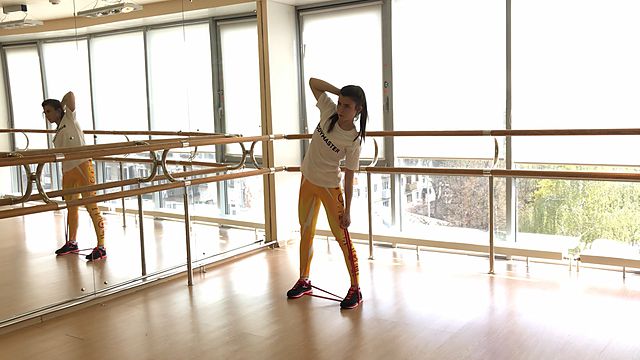 Photo of Body side tilts with a rubber band exercise
