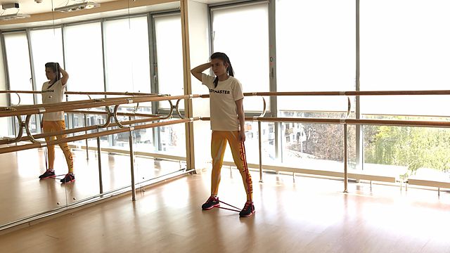 Photo of Body side tilts with a rubber band exercise