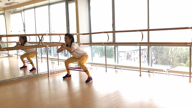 Photo of Walking in a squat position using a mini band exercise