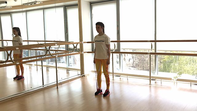 Photo of Standing Shrugs with a rubber band exercise