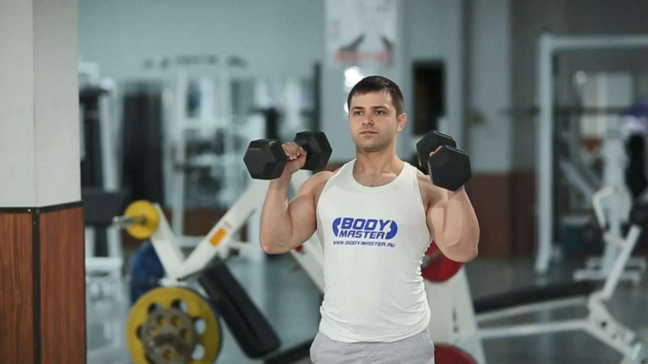 Exercise Standing Palms-In Dumbbell Press 