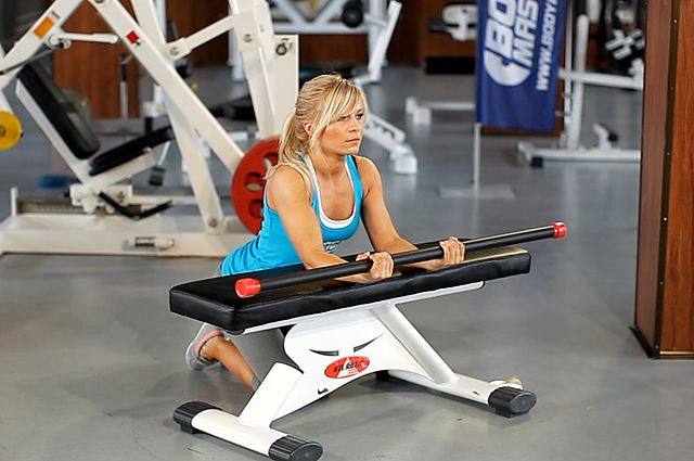 Photo of Palms-Up Barbell Wrist Curl Over A Bench exercise