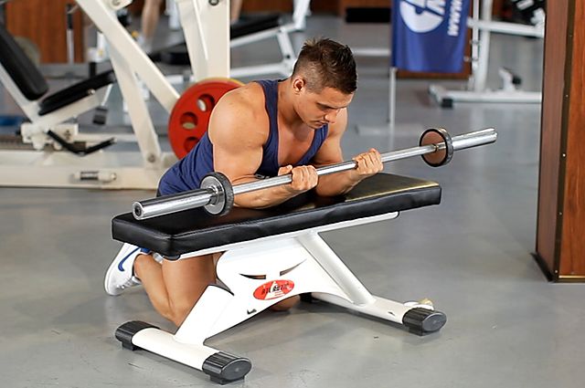 Photo of Palms-Up Barbell Wrist Curl Over A Bench exercise
