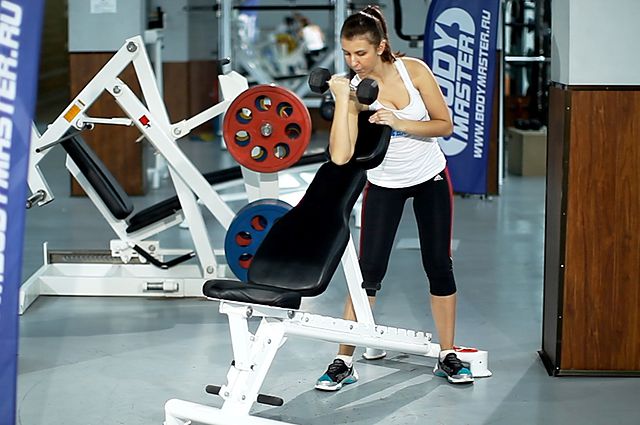 Photo of Standing One-Arm Dumbbell Curl Over Incline Bench  exercise